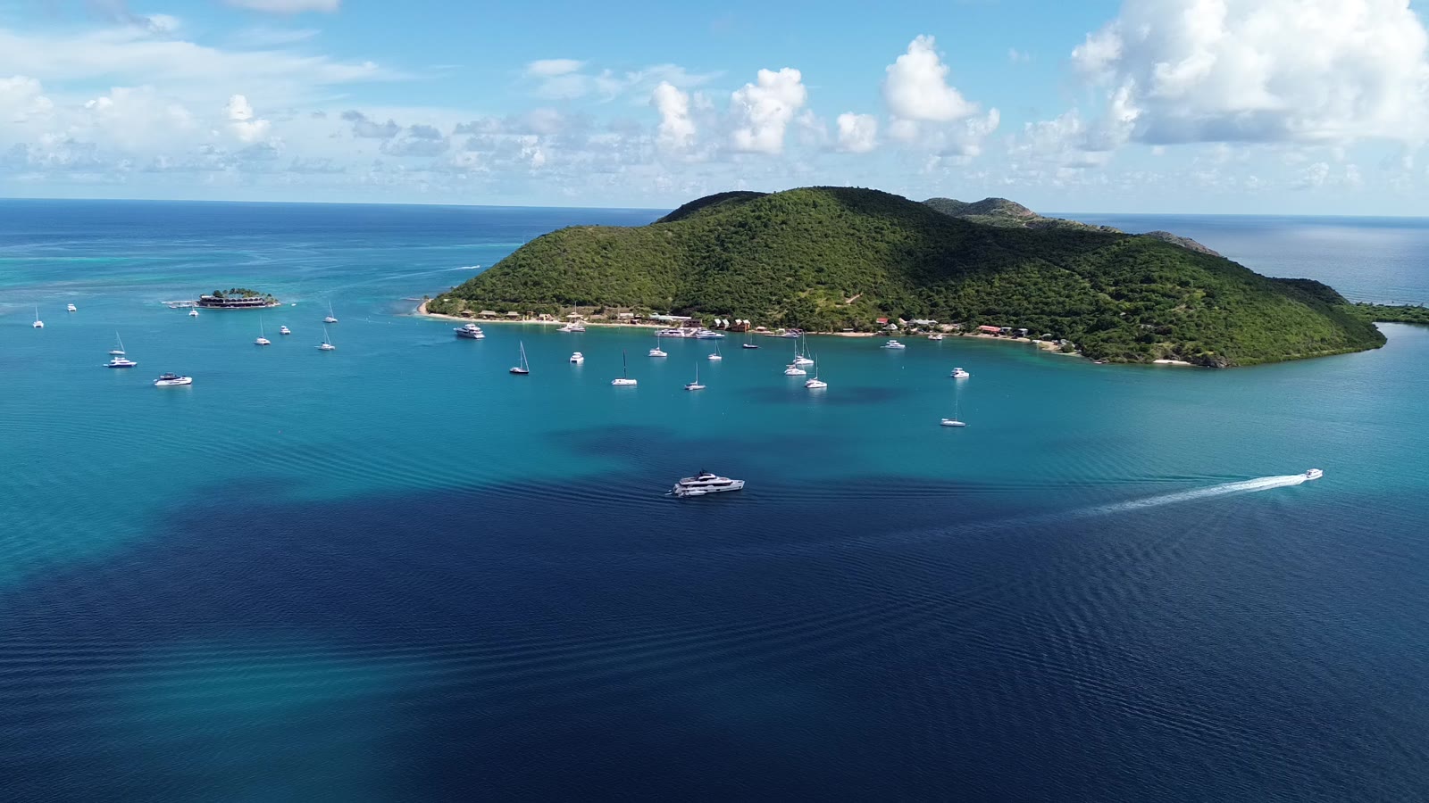 Coming into North Sound, Virgin Gorda, from the air, with yachts moored off a green island